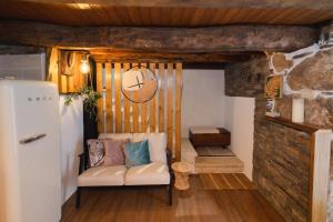 a living room with a couch and a refrigerator at Casa do Cancelo in Mondim de Basto
