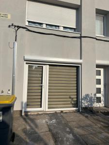 two garage doors on the side of a building at Chez mohamed in Mons-en-Baroeul