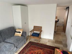a living room with a couch and a chair at Chez mohamed in Mons-en-Baroeul