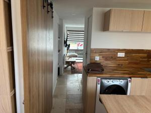 a kitchen with a dishwasher next to a hallway at Chez mohamed in Mons-en-Baroeul