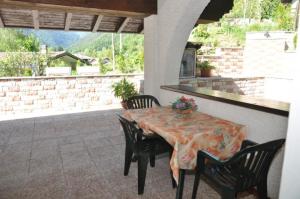 a table and chairs sitting on a patio at B&B Villa Cinzia Ledro in Ledro