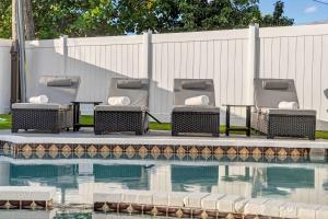 two chairs and a table next to a swimming pool at Home at Boulevard Heights, Hollywood in Hollywood