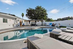 a swimming pool with lounge chairs and a house at Home at Boulevard Heights, Hollywood in Hollywood