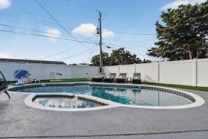 a swimming pool with chairs in a yard at Home at Boulevard Heights, Hollywood in Hollywood