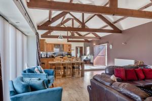 a living room with a couch and chairs and a kitchen at 3 Bed in Thwing oc-t29011 in Thwing