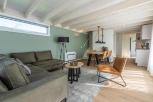 a living room with a couch and a table at EuroParcs Cadzand-Bad in Cadzand