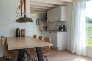 a kitchen and dining room with a table and chairs at EuroParcs Cadzand-Bad in Cadzand