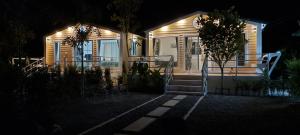 a house lit up at night with a table and chairs at วันรีสอร์ท in Ratchaburi +14 photos