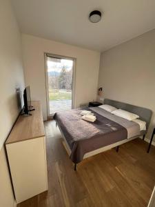 a bedroom with a large bed and a window at River House in Lazeshchyna