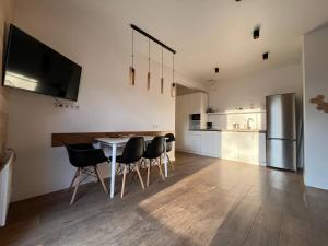 a kitchen with a table and chairs and a refrigerator at River House in Lazeshchyna