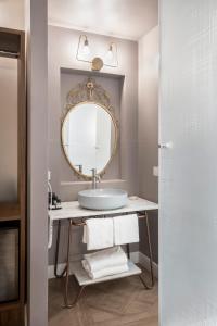 a bathroom with a sink and a mirror at 19 Steps Trevi in Rome +3 photos