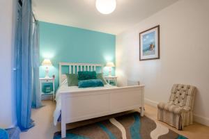 a bedroom with a white bed and a chair at 2 Bed in Whitby oc-h31801 in Whitby