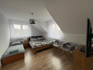 a bedroom with a bed and a table and chairs at Biebrzańska Dolina 1 in Goniadz