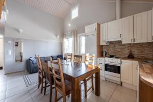 a kitchen with a table and chairs in a room at Villa Magnolia 2 Himos in Jämsä +19 photos
