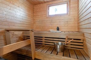 a wooden sauna with a sink and a window at Villa Magnolia 2 Himos in Jämsä
