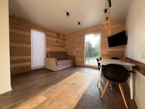 a living room with a desk and a couch at River House in Lazeshchyna