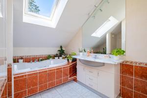 a bathroom with a tub and a sink at Cosy Loft in Nantes in Nantes +24 photos