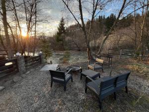 a group of chairs and a table and a fire pit at River House in Lazeshchyna