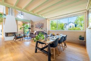 a dining room and living room with a table and chairs at Cosy Loft in Nantes in Nantes