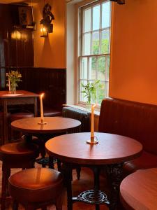 two tables in a restaurant with candles on them at The Black Horse in Amberley