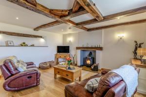 a living room with leather furniture and a fireplace at 2 Bed in Pickering oc-t29975 in Middleton