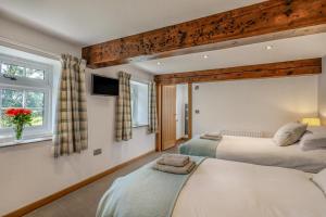 a bedroom with two beds and a tv on the wall at 2 Bed in Pickering oc-t29975 in Middleton