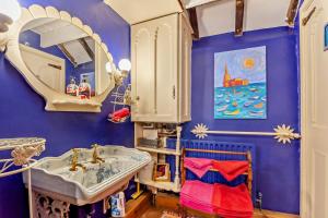 a blue bathroom with a sink and a mirror at 1 Bed in Long Bennington oc-t29871 in Long Bennington +14 photos