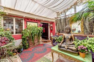a statue sitting on a table in a room with plants at 1 Bed in Long Bennington oc-t29871 in Long Bennington