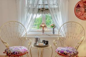 two chairs and a table in front of a window at 4 Bed in Long Bennington oc-p29872 in Long Bennington