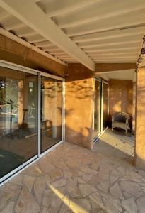 an empty patio with glass doors on a house at Loucasa Location les Issambres in Les Issambres