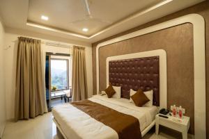 a bedroom with a large bed and a window at Krushnai Resort in Kharakvasla +16 photos