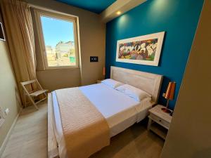 a bedroom with a large bed and a window at White House in Trani