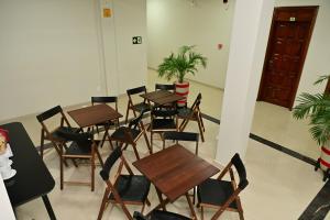 a group of tables and chairs in a room at Frota Palace Hotel in Macapá