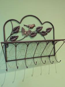 a metal shelf with two hearts and two butterflies at Coastal Whisper Sleeps 10 with Parking in Reighton +22 photos