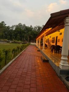 a brick walkway next to a yellow building at Bougainvillea in Chikmagalūr +57 photos