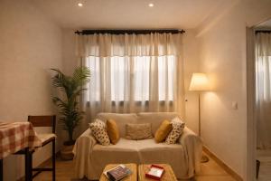 a living room with a couch in front of a window at Apartament a Sant Celoni, Montseny, Barcelona in Sant Celoni