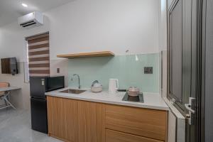 a kitchen with a sink and a refrigerator at An Thy HOTEL in Vung Tau