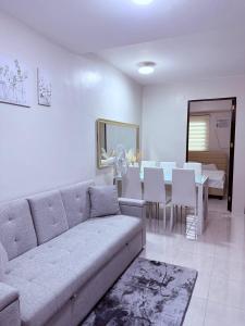 a living room with a couch and a dining room at Vernes Homestay in Mandaue City
