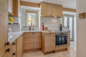 a kitchen with wooden cabinets and a stove at 2 Bed in Helmsley oc-p36613 in Helmsley