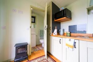 a kitchen with a wood stove in a kitchen at 1 Bed in Raunds oc-s33685 in Raunds