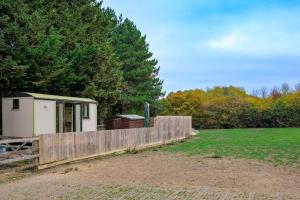 a wooden fence in front of a field with a shed at 1 Bed in Raunds oc-s33685 in Raunds
