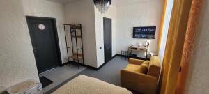 a living room with a couch and a table at Антарес Отель in Shemonaīkha