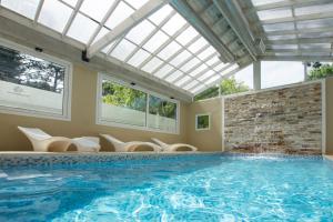 a swimming pool with a skylight in a house at Complejo Viva Zapata in Mar de las Pampas
