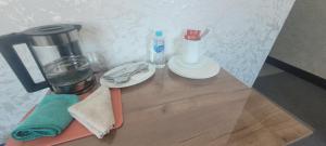 a counter top with a coffee maker and a blender at Антарес Отель in Shemonaīkha +41 photos