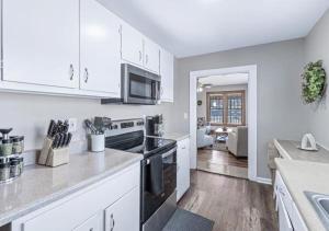 a kitchen with white cabinets and a stove top oven at Red Bud in Chattanooga