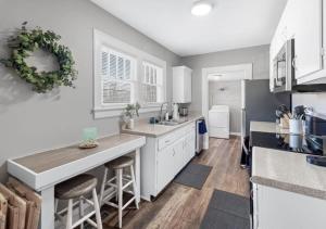 a kitchen with white cabinets and a counter top at Red Bud in Chattanooga