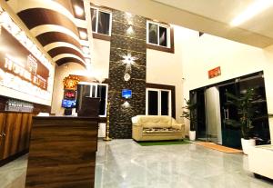 a lobby with a chair in a building at Hotel ELITE Rameswaram in Rāmeswaram