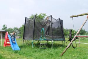 two people are playing on a trampoline at Hof Kricheleberg in Bocholtz