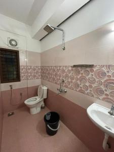 a bathroom with a toilet and a sink at Southern Cliff House in Varkala +30 photos