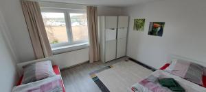 a small room with two beds and a window at 40L 3OG r in Castrop-Rauxel